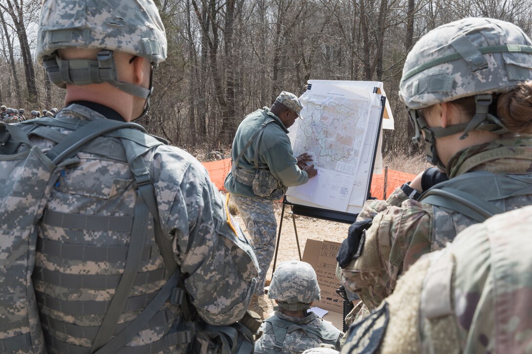 A soldier writes on a map during navigation training.