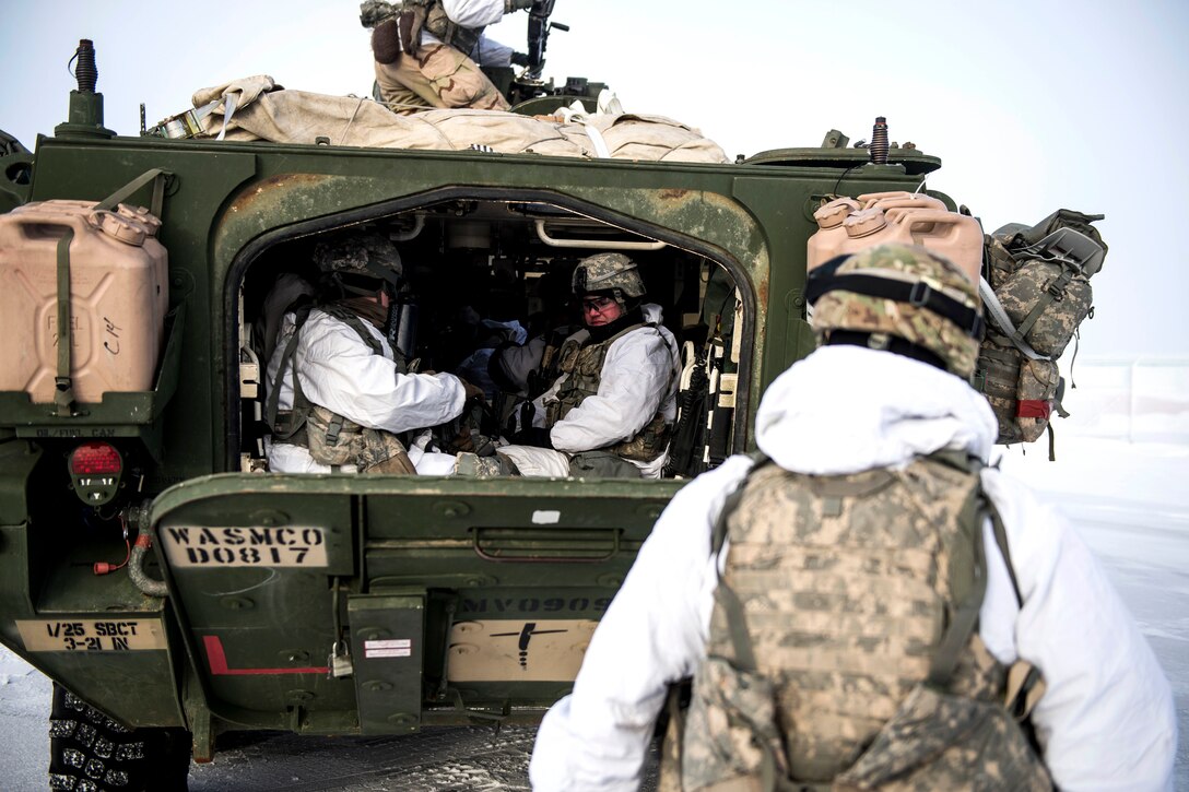 Soldiers load into a M1126 Stryker combat vehicle.