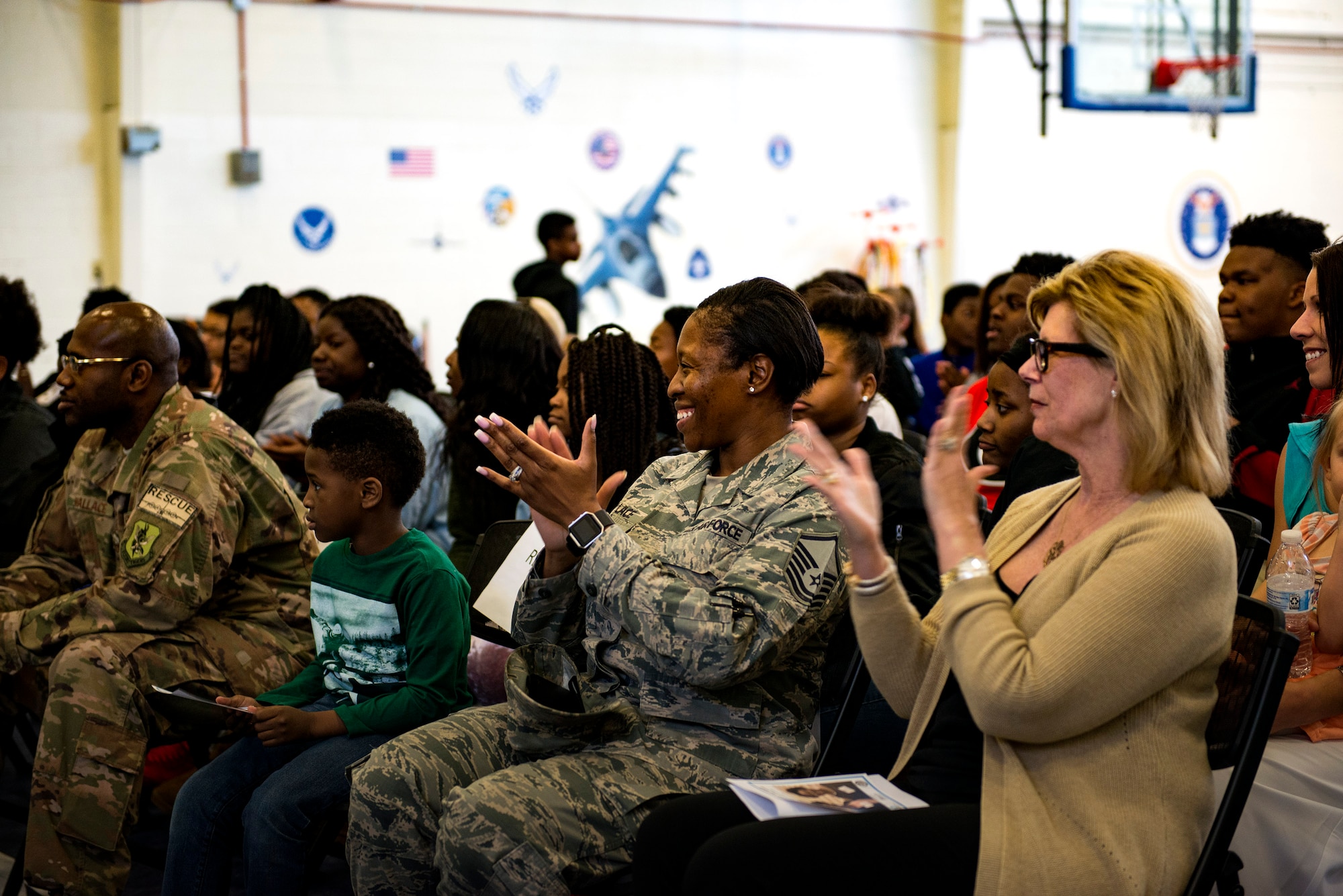 Audience members congratulate the arrival of Nevaeh Wallace, daughter of Master Sgt. Marvin Wallace, 723d Aircraft Maintenance Squadron first sergeant, and Master Sgt. Yolanda Wallace, 23d Wing chapel assistant, along with Brandace Jones, daughter of Carlos Jones, unit director for the Boys and Girls Club of Lake Laurie, during the Youth of the Year Finalist Celebration, March 23, 2018, at Moody Air Force Base, Ga. The Youth Center hosted the event to give parents and community members a chance to see the competitors give their speeches they presented during the Georgia State Youth of the Year Competition. This was the first time two competitors from southeast region made it to the semifinals at the same time. (U.S. Air Force photo by Airman 1st Class Erick Requadt)