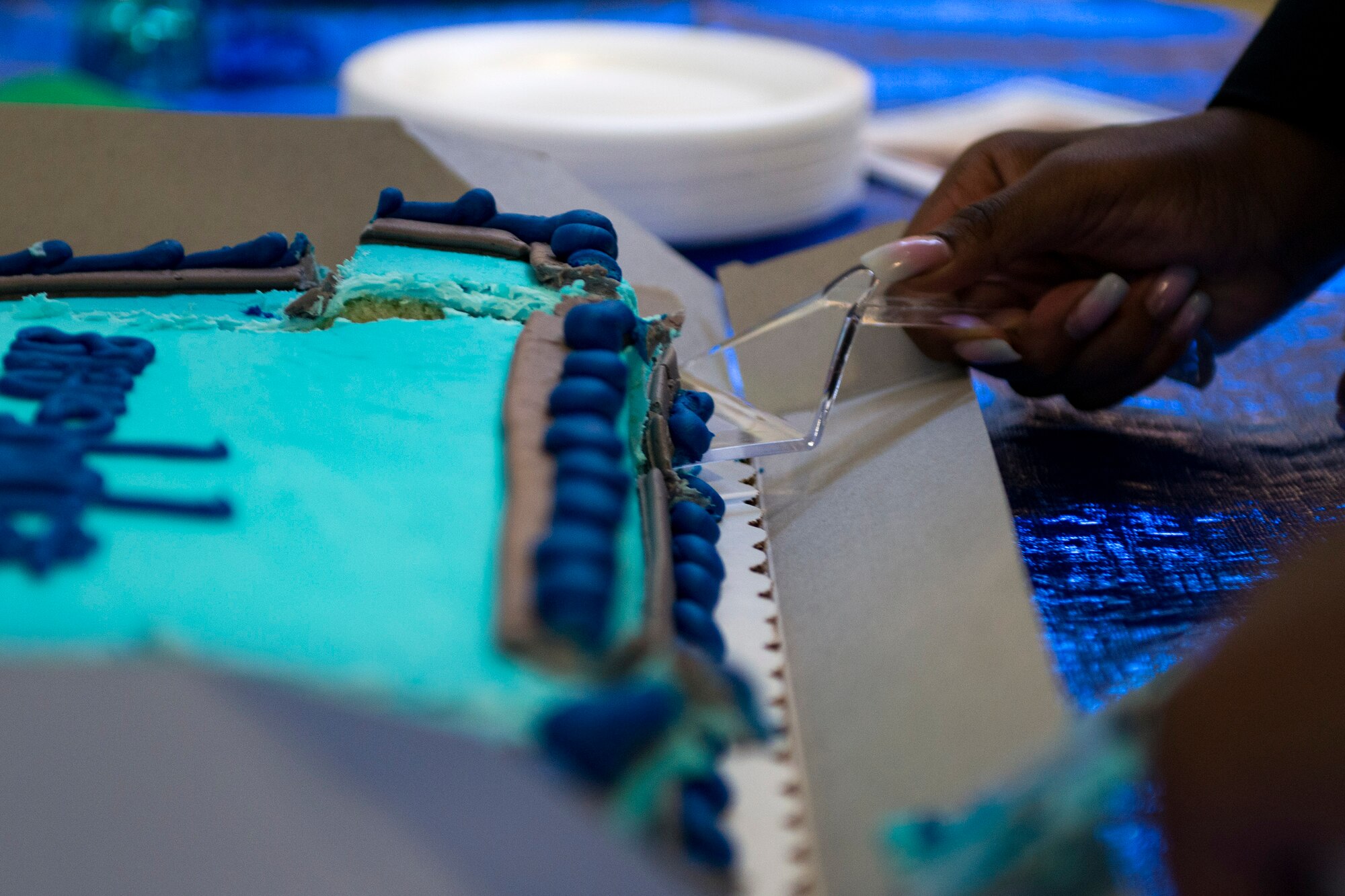 Nevaeh Wallace, daughter of Master Sgt. Marvin Wallace, 723d Aircraft Maintenance Squadron first sergeant, and Master Sgt. Yolanda Wallace, 23d Wing chapel assistant, cuts a cake during the Youth of the Year Finalist Celebration, March 23, 2018, at Moody Air Force Base, Ga. The Youth Center hosted the event to give parents and community members a chance to see the competitors give their speeches they presented during the Georgia State Youth of the Year Competition. This was the first time two competitors from southeast region made it to the semifinals at the same time. (U.S. Air Force photo by Airman 1st Class Erick Requadt)