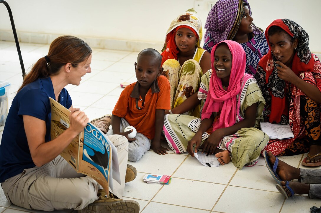 A soldiers teaches English to children in Djibouti