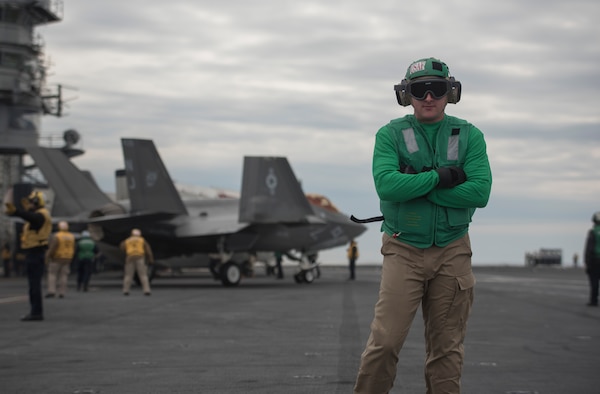 U.S. Air Force 1st Lieutenant Sean Duval, 33rd Maintenance Squadron maintenance operations officer, stands in front of an F-35A Lightning II March 19, 2018, on the Nimitz-class aircraft carrier USS Abraham Lincoln (CVN-72). Duval took part in a maintenance officer exchange to learn about the differences and similarities between Air Force and Navy F-35 operations. (U.S. Air Force photo by Staff Sgt. Peter Thompson/Released)
