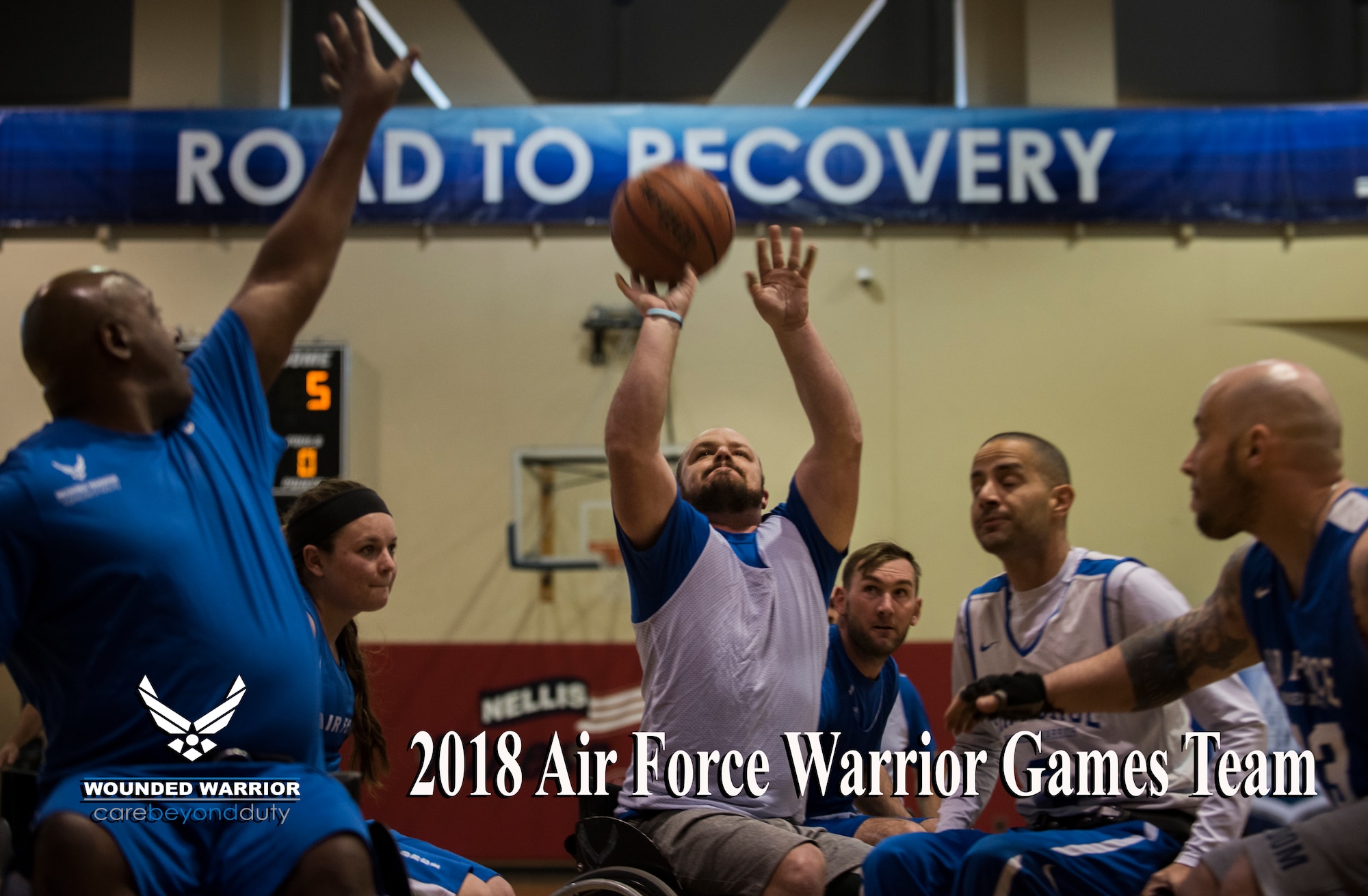 A competitor shoots while surrounded by defenders during the wheelchair basketball event in the 5th Annual Air Force Wounded Warrior Trials at the Warrior Fitness Center on Nellis Air Force Base, Nevada, Feb. 28, 2018.