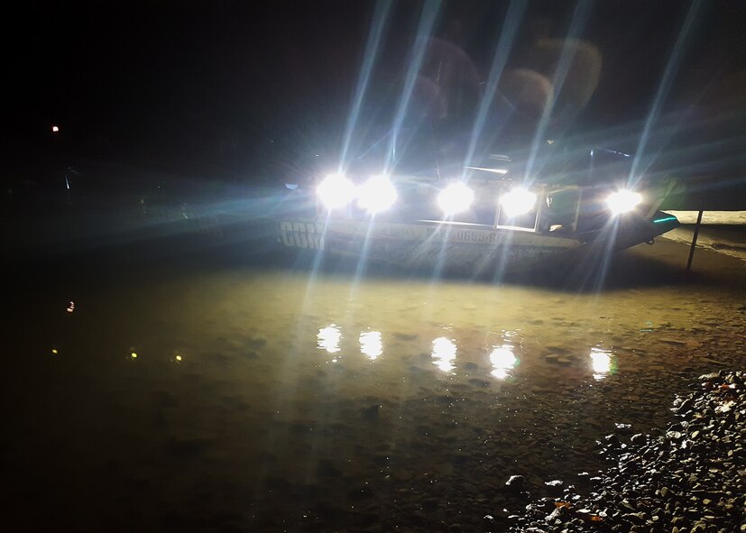 Boat rigged for night fishing sits in the water.
