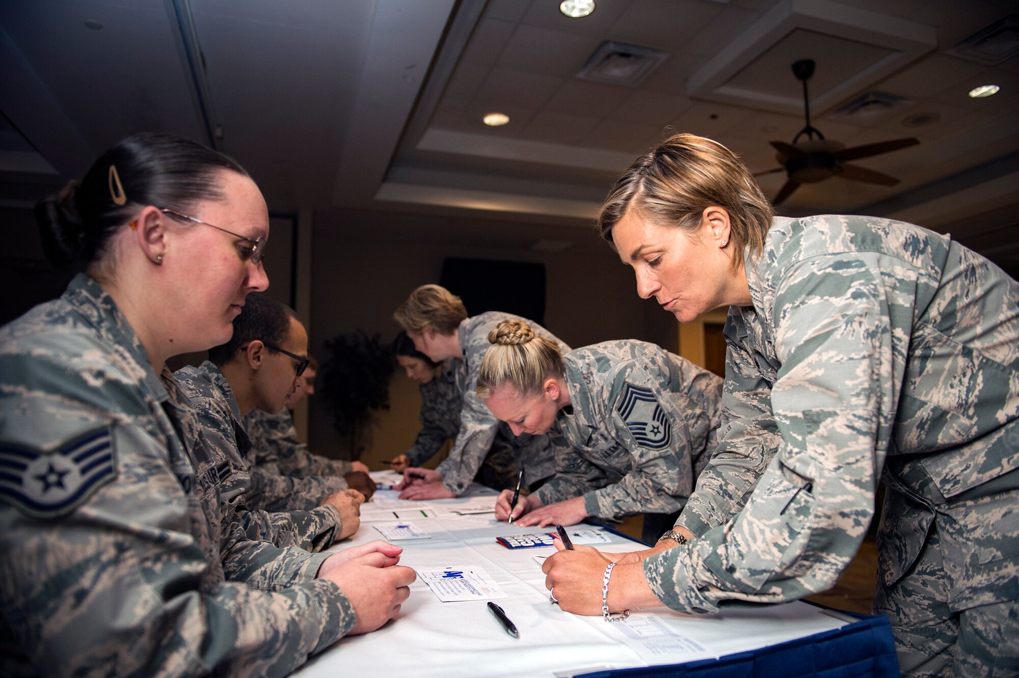 Col. Jennifer Short, 23d Wing commander, signs a 2018 Air Force Assistance Fund donation packet, March 26, at Moody Air Force Base, Ga. The AFAF helps current and fellow Airmen in need to overcome financial hardships. Maximum participation from the Flying Tigers will help reach their goal of collecting $70,469. (U.S. Air Force photo by Senior Airman Greg Nash)