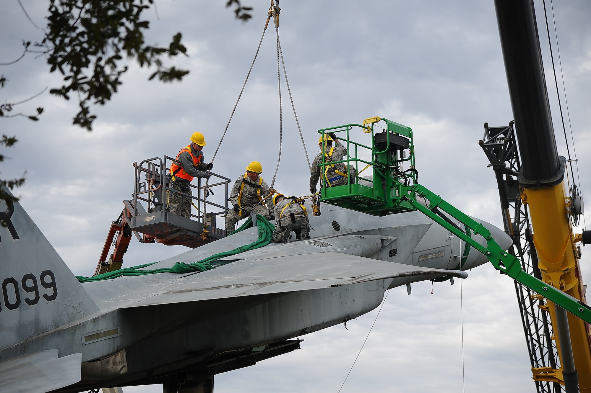 The 402nd Aircraft Maintenance Group removes the F-15 display and transports to the paint shop.