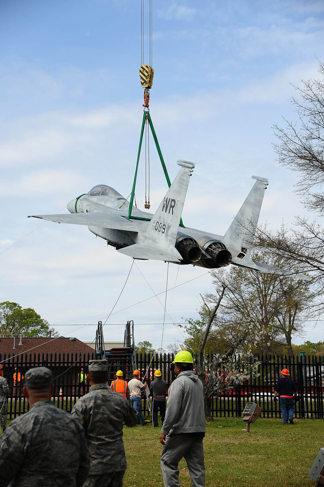 The 402nd Aircraft Maintenance Group removes the F-15 display and transports to the paint shop.
