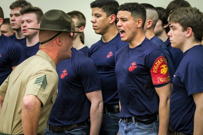 Sgt. Jordan Brown, drill instructor, 1st Recruit Training Regiment, yells commands at Skylar Popillion, a Gilbert, Iowa, native and enlistee in the Marine Corps during a Drill Instructor Family Night at Events Center West in West Des Moines, Iowa, March 23, 2018. Marine Corps Recruiting Command hosts the family nights to better prepare both parent and enlistee prior to attending Marine Corps Recruit Training. (Official U.S. Marine Corps photo by Sgt. Levi Schultz)