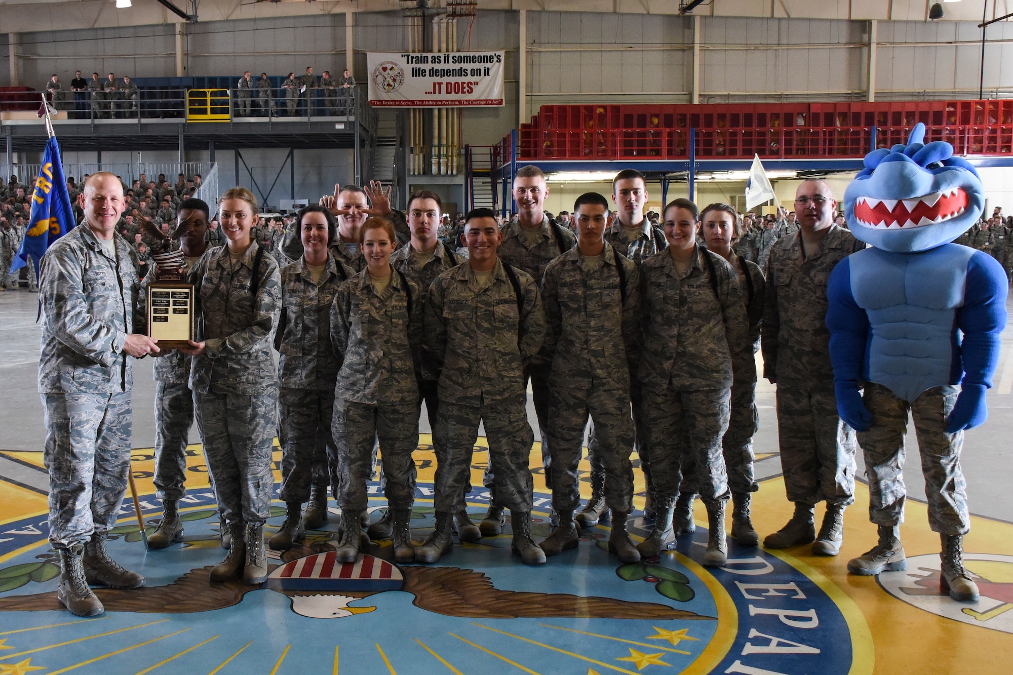 The 316th Training Squadron drill team poses with the first place award for the regulation drill portion of the 17th Training Group drill competition at the Louis F. Garland Department of Defense Fire Academy on Goodfellow Air Force Base, Texas, March 23, 2018. To win the regulation drill segment of the competition the team has to show discipline, precision and unity. (U.S. Air Force photo by Airman 1st Class Zachary Chapman/Released)