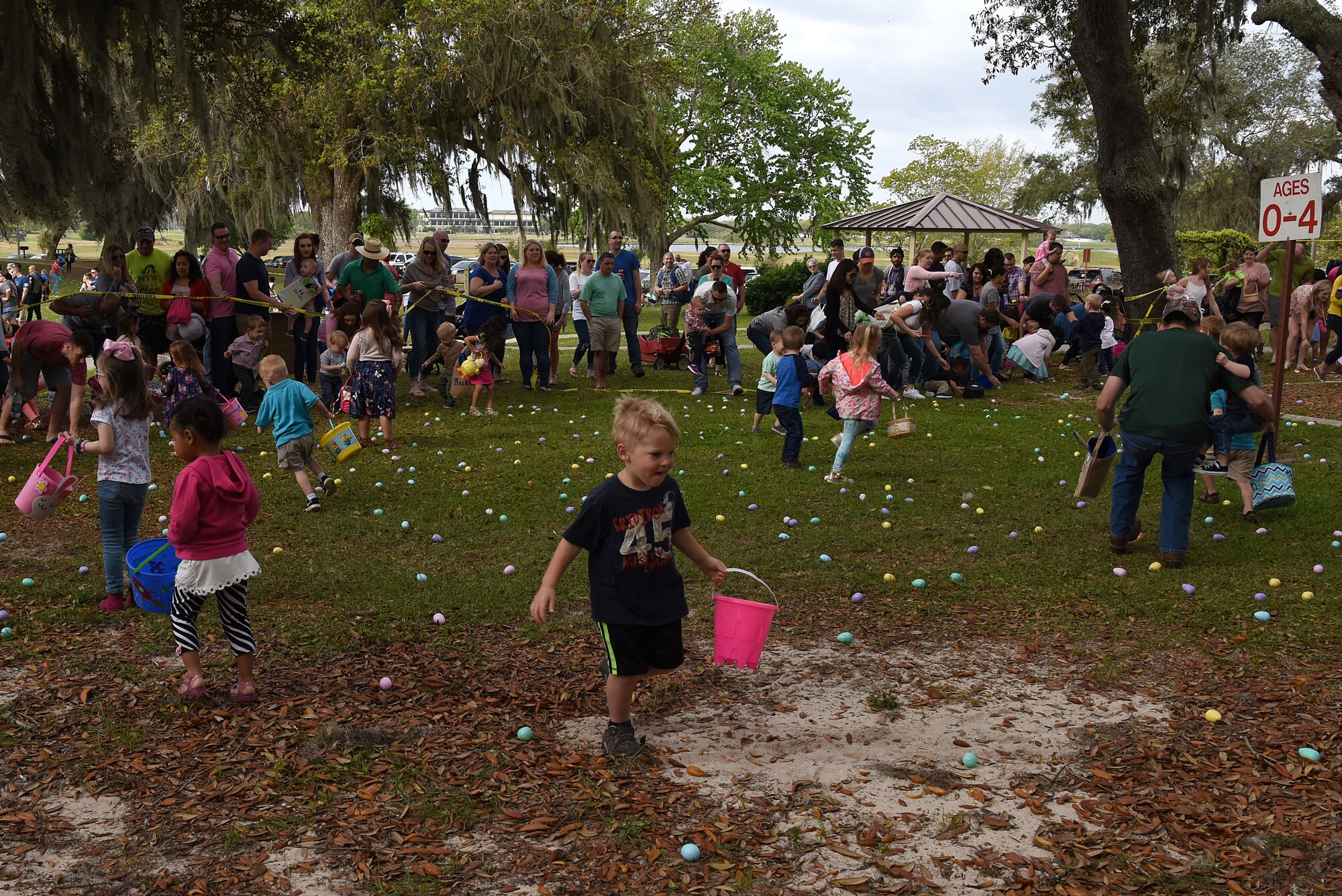 Keesler children participate in an Easter egg hunt during Easter in the Park at Marina Park March 24, 2018, on Keesler Air Force Base, Mississippi. The event festivities also included a parade, arts and crafts and informational booths. (U.S. Air Force photo by Airman 1st Class Suzie Plotnikov)