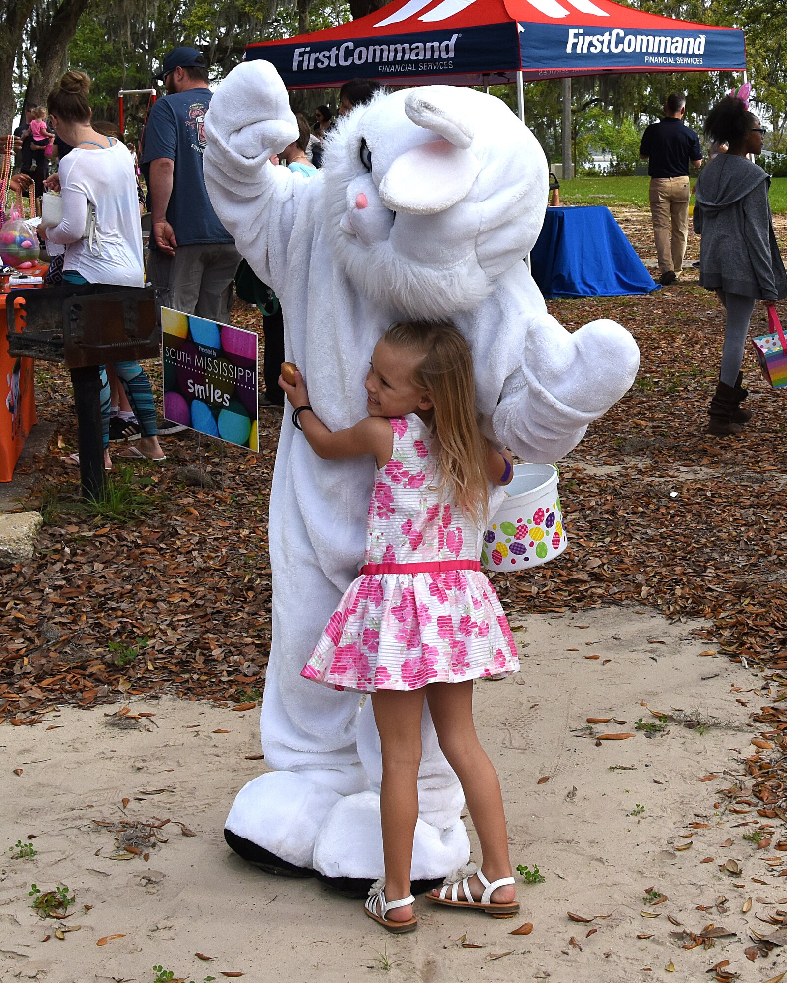 Makai Surber, daughter of U.S. Air Force Master Sgt. Chontee Surber, 81st Dental Squadron clinical flight chief, takes a picture with the Easter bunny during Easter in the Park at Marina Park March 24, 2018, on Keesler Air Force Base, Mississippi. The event festivities included a parade, an Easter egg hunt, arts and crafts and informational booths. (U.S. Air Force photo by Airman 1st Class Suzie Plotnikov)