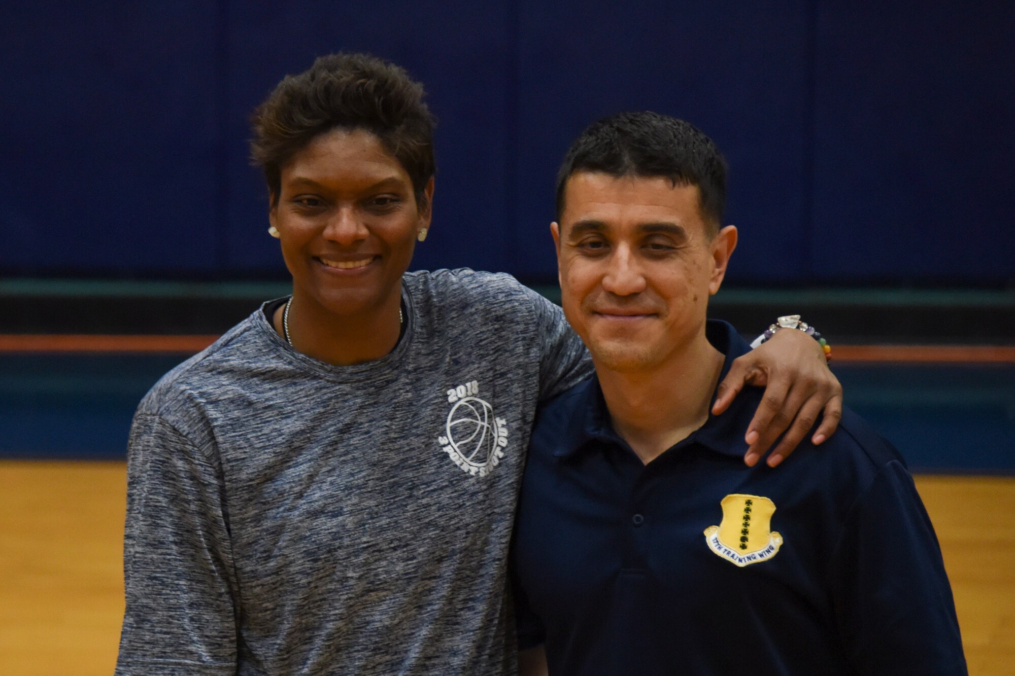 2017 NCAA Women’s Final Four Ambassador, Alicia Thompson poses with U.S. Air Force Col. Ricky Mills, 17th Training Wing commander, during the 3-on-3 tournament at the Mathis Fitness Center on Goodfellow Air Force Base, Texas, March 24, 2018. Thompson has visited Goodfellow before and shared during her speech that she hopes to continue visiting Goodfellow in the future. (U.S. Air Force photo by Airman 1st Class Zachary Chapman/Released)