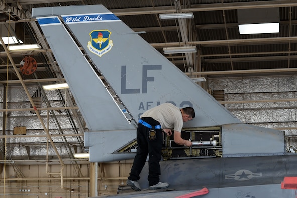 Senior Airman Tanner Apple, 309th Aircraft Maintenance Unit dedicated crew chief, inspects the flight control accumulator , March 22, 2018 at Luke Air Force Base, Ariz. Apple was named the Air Education and Training Command crew chief of the year for 2017 and now competing at the Air Force-level. (U.S. Air Force Photo by Senior Airman Pedro Mota)