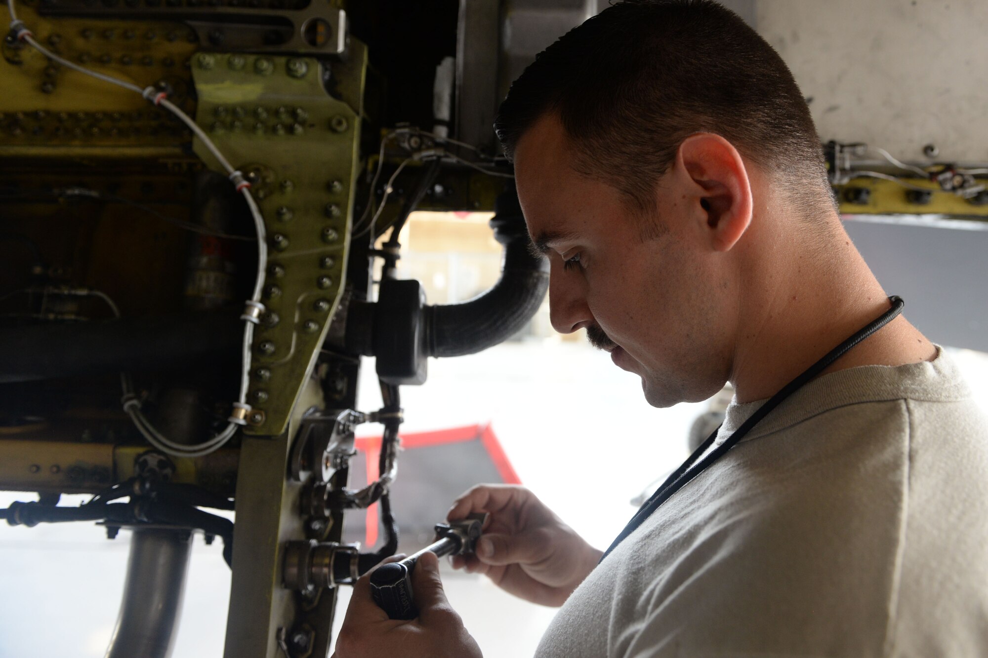 Senior Airman Tanner Apple, 309th Aircraft Maintenance Unit dedicated crew chief, conducts an engine bay inspection, March 22, 2018 at Luke Air Force Base, Ariz. Apple inspects a pin for cracks or damage, which connects the engine to the F-16 Fighting Falcon chassis. (U.S. Air Force Photo by Senior Airman Pedro Mota)