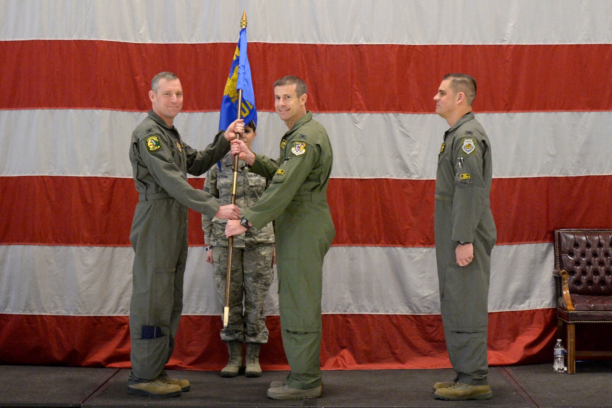 Col. David Smith, 419th Fighter Wing commander, passes the group flag to Col. Sean Carpenter, the new commander of the 419th Operations Group