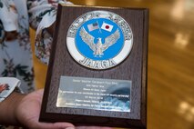 Shereda Riley, wife of Senior Master Sgt. Paul Riley, the 35th Maintenance Squadron armament flight chief, holds the Japan-American Air Force Goodwill Association Award at Misawa Air Base, Japan, March, 20, 2018. Since Riley left his hometown of Stockton, Georgia, to make a positive impact in the world, he said receiving this award made him feel accomplished and grateful. (U.S. Air Force photo by Airman 1st Class Collette Brooks)