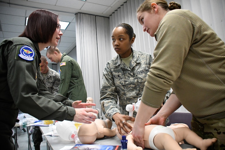 U.S. Air Force Staff Sgt. April White, left, 932nd Airlift Wing Aeromedical Evacuation Squadron medical technician, helps explain the methods for taking care of babies and small children during a refresher class at the 932nd Medical Group, Scott Air Force Base, Ill., March 6, 2018. Previously, she was presented with a chief's coin by Chief Master Sgt. Ericka Kelly, Command Chief, Air Force Reserve Command, for being a standout Airman and for her self-improvements and positive attitude. (U.S. Air Force photo by Lt. Col. Stan Paregien)