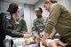 U.S. Air Force Staff Sgt. April White, left, 932nd Airlift Wing Aeromedical Evacuation Squadron medical technician, helps explain the methods for taking care of babies and small children during a refresher class at the 932nd Medical Group, Scott Air Force Base, Ill., March 6, 2018. Previously, she was presented with a chief's coin by Chief Master Sgt. Ericka Kelly, Command Chief, Air Force Reserve Command, for being a standout Airman and for her self-improvements and positive attitude. (U.S. Air Force photo by Lt. Col. Stan Paregien)