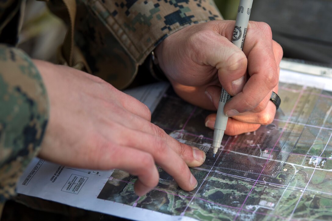 A U.S. Marine plots a point as part of land navigation training during a U.S. Marine Corps Forces Central Command (MARCENT) noncommissioned officer (NCO) field exercise at MacDill Air Force Base, Fla., March 14-15, 2018. MARCENT hosted this exercise to refresh proficiency in basic infantry and develop NCO skills.