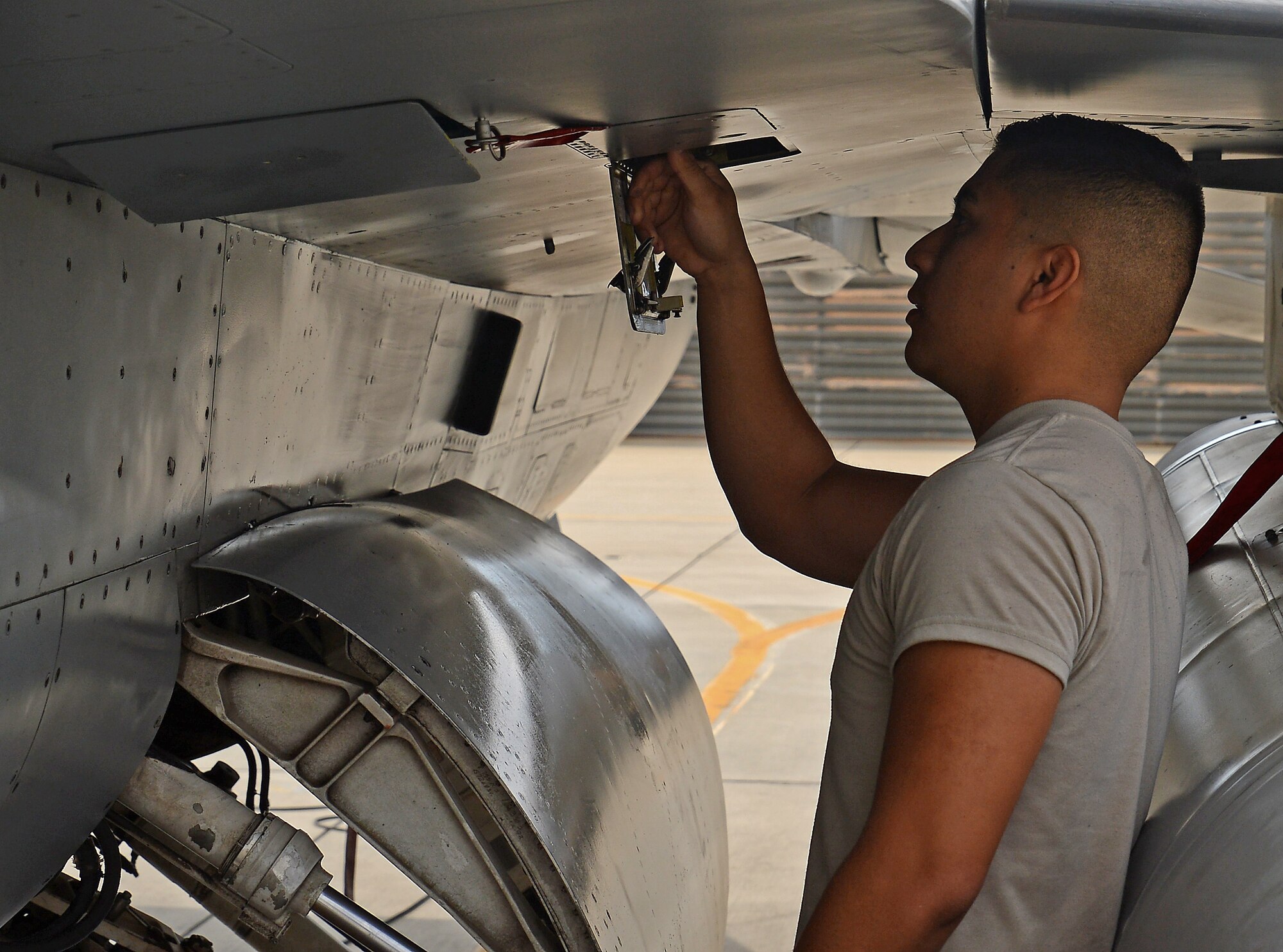 Senior Airman Kevin Zaragoza, 455th Expeditionary Aircraft Maintenance Squadron F-16 Fighting Falcon crew chief, inspects a gear box on an F-16 Mar. 20, 2018 at Bagram Airfield, Afghanistan.