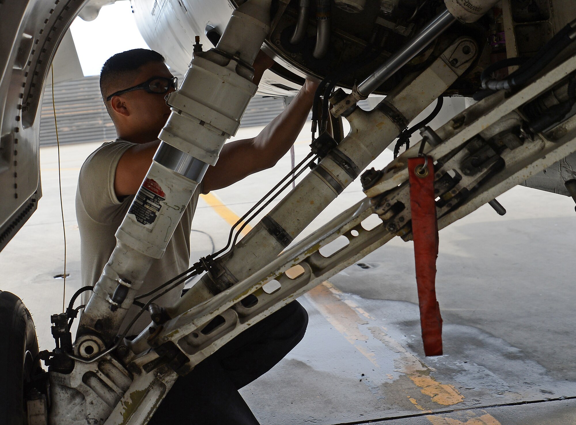 Senior Airman Kevin Zaragoza, 455th Expeditionary Aircraft Maintenance Squadron F-16 Fighting Falcon crew chief, inspects the accessory drive gearbox during his preflight inspection Mar. 20, 2018 at Bagram Airfield, Afghanistan.