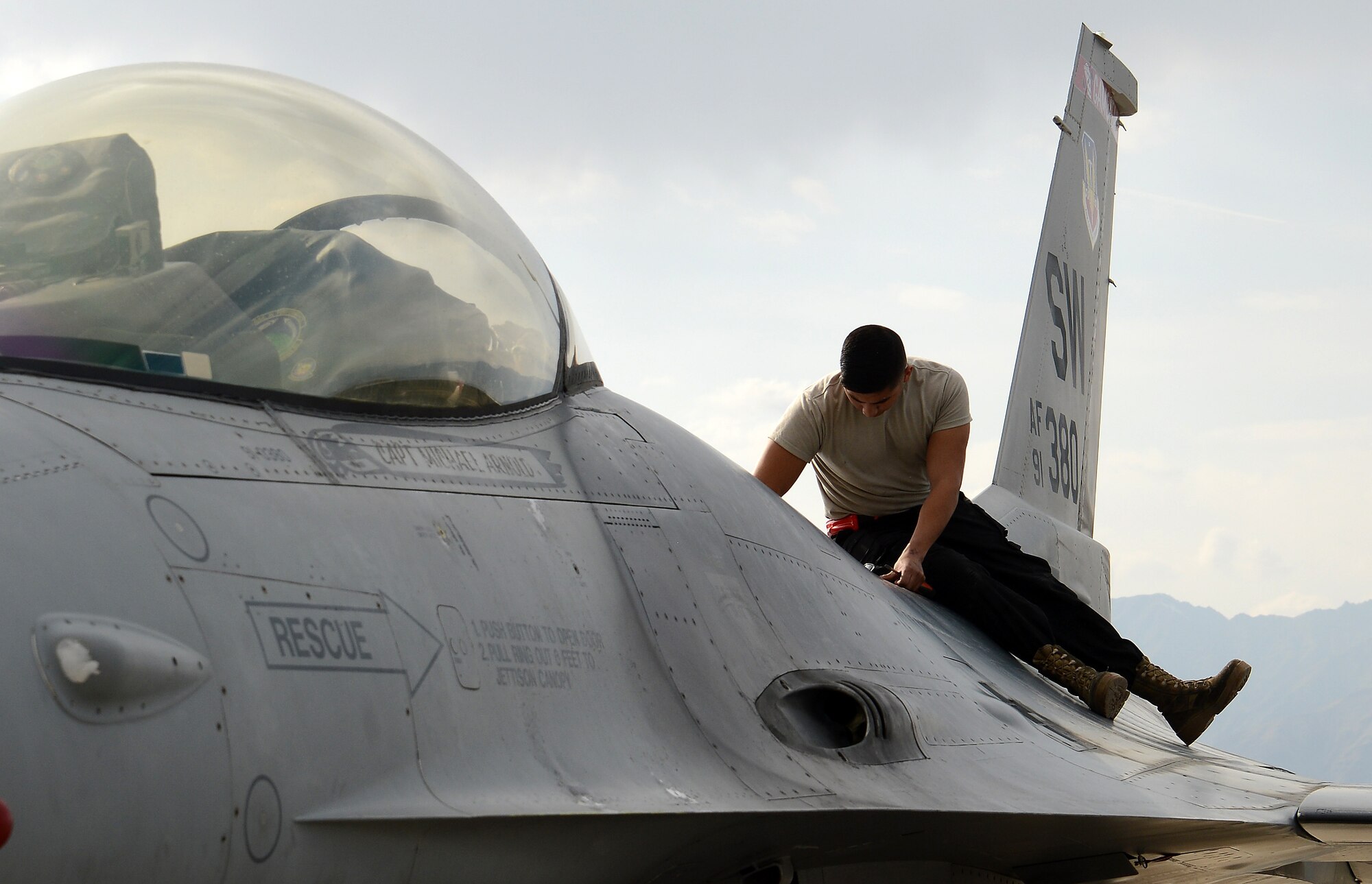 Senior Airman Kevin Zaragoza, 455th Expeditionary Aircraft Maintenance Squadron F-16 Fighting Falcon crew chief, inspects the air refueling door during his preflight inspection Mar. 20, 2018 at Bagram Airfield, Afghanistan.