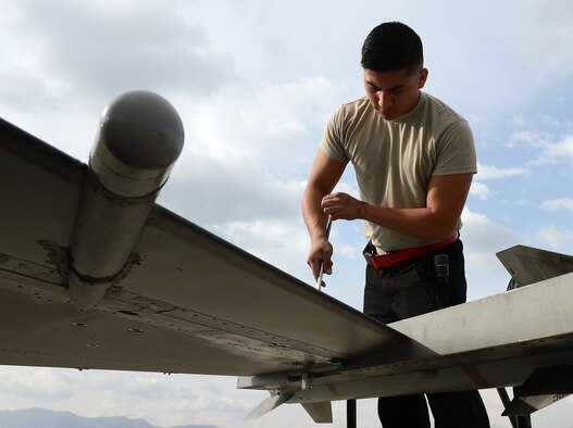 Senior Airman Kevin Zaragoza, 455th Expeditionary Aircraft Maintenance Squadron F-16 Fighting Falcon crew chief, tightens up a screw on the wing of an F-16 Mar. 20, 2018 at Bagram Airfield, Afghanistan.