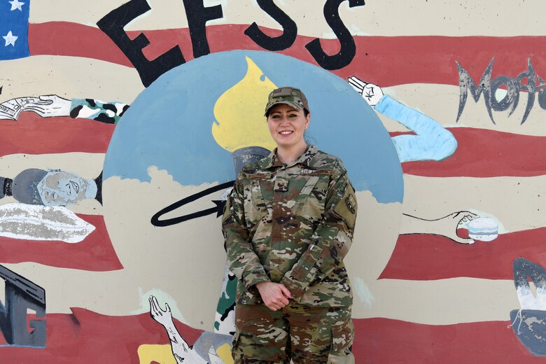 U.S. Air Force Tech. Sgt. Lucinda Windham, 407th Expeditionary Force Support Squadron non-appropriated funds custodian, stands near the 407th EFSS t-wall at an undisclosed location in Southwest Asia, March 8, 2018. Windham is responsible for tracking and budgeting non-appropriated funds. (U.S. Air Force photo by Staff Sgt. Joshua Edwards/Released)