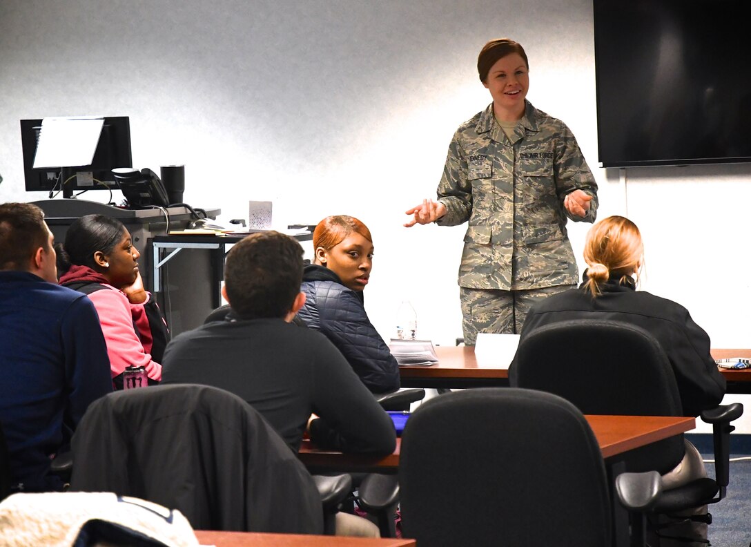 Staff Sgt. Kaitlyn Kennedy, 932nd Airlift Wing Development and Training Flight Coordinator, answers questions from new Airmen, during a recent training weekend at Scott Air Force Base, Ill. She uses a planning project board for upcoming months, keeping track of Airmen as they come and go from the initial orientation courses to basic training. She also helps counsel new trainees on paperwork and assists the recruiting team in the headquarters building as needed. (U.S. Air Force photo by Lt. Col. Stan Paregien)