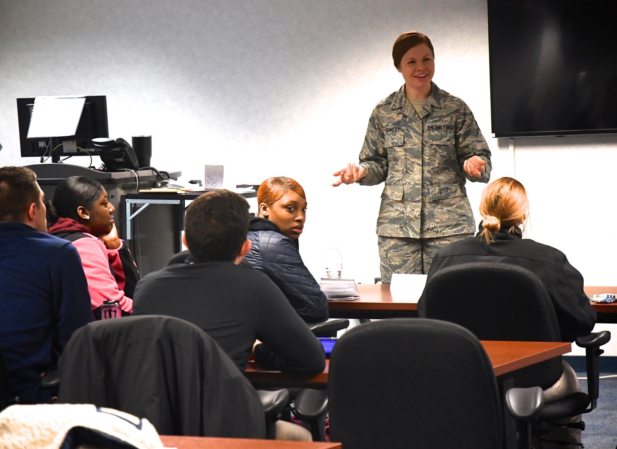 Staff Sgt. Kaitlyn Kennedy, 932nd Airlift Wing Development and Training Flight Coordinator, answers questions from new Airmen, during a recent training weekend at Scott Air Force Base, Ill. She uses a planning project board for upcoming months, keeping track of Airmen as they come and go from the initial orientation courses to basic training. She also helps counsel new trainees on paperwork and assists the recruiting team in the headquarters building as needed. (U.S. Air Force photo by Lt. Col. Stan Paregien)