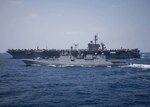 INDIAN OCEAN (March 25, 2018) The Indian Navy Talwar-class frigate INS Tarkash (F50) transits alongside the aircraft carrier USS Theodore Roosevelt (CVN 71). Theodore Roosevelt is currently underway for a regularly scheduled deployment in the U.S. 7th Fleet area of operations in support of maritime security operations and theater security cooperation efforts.