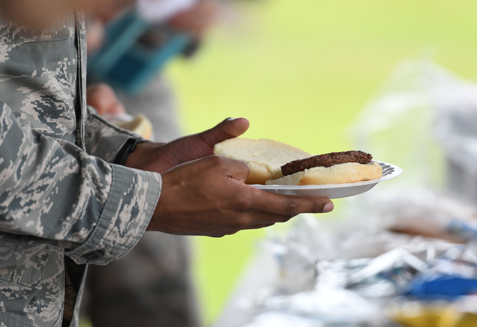 U.S. Air Force Staff Sgt. Tony Galloway, 81st Diagnostic and Therapeutics Squadron radiology technician, holds a plate of food during the Air Force Assistance Fund burger burn at the Crotwell Track March 26, 2018, on Keesler Air Force Base, Mississippi. The AFAF is an annual effort to raise funds for charitable affiliates that provide support to our Air Force family in need. (U.S. Air Force photo by Kemberly Groue)