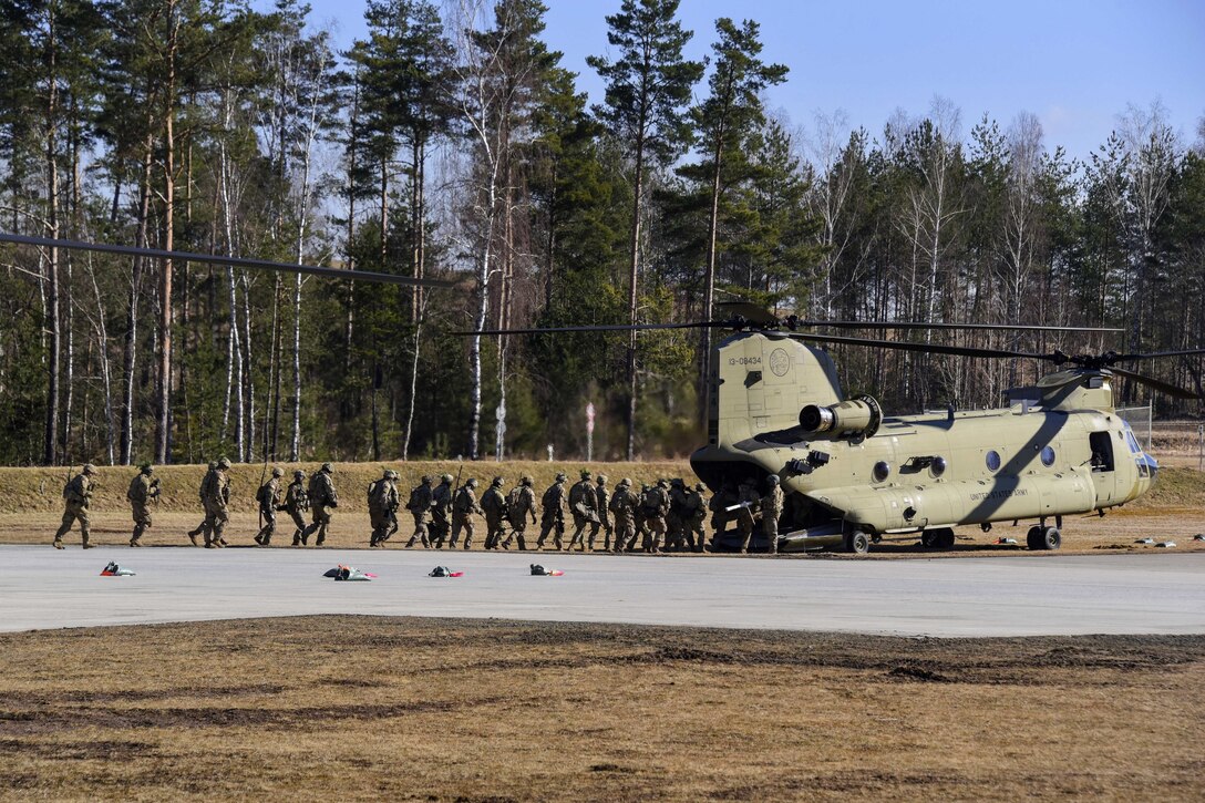 Soldiers board a CH-47 Chinook helicopter.