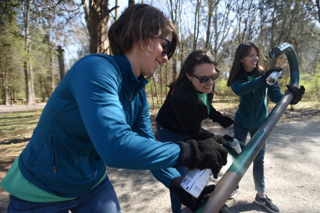 (Left to Right) Amy Gardner, merchandizing manager; Katy Green, merchandizer; and Cassie McLure, merchandizer; with VF Solutions, paint a utility post while volunteering for an early Earth Day clean-up event March 22, 2018 at Seven Points Campground on the shoreline of J. Percy Priest Lake in Hermitage, Tenn. Sixty VF Solutions employees partnered with the U.S. Army Corps of Engineers Nashville District to spruce up the popular campground ahead of the 2018 recreation season. (USACE photo by Lee Roberts)