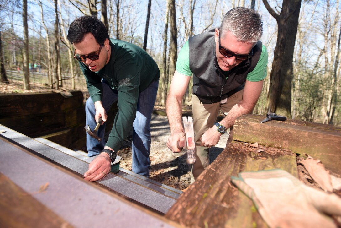 Pat Kopf (Right), chief finance officer with V.F. Workwear, and Keith Steward, vice president of customer relations with VF Solutions, install traction strips on wood steps at a campsite while volunteering for an early Earth Day clean-up event March 22, 2018 at Seven Points Campground on the shoreline of J. Percy Priest Lake in Hermitage, Tenn. Sixty VF Solutions employees partnered with the U.S. Army Corps of Engineers Nashville District to spruce up the popular campground ahead of the 2018 recreation season. (USACE photo by Lee Roberts)