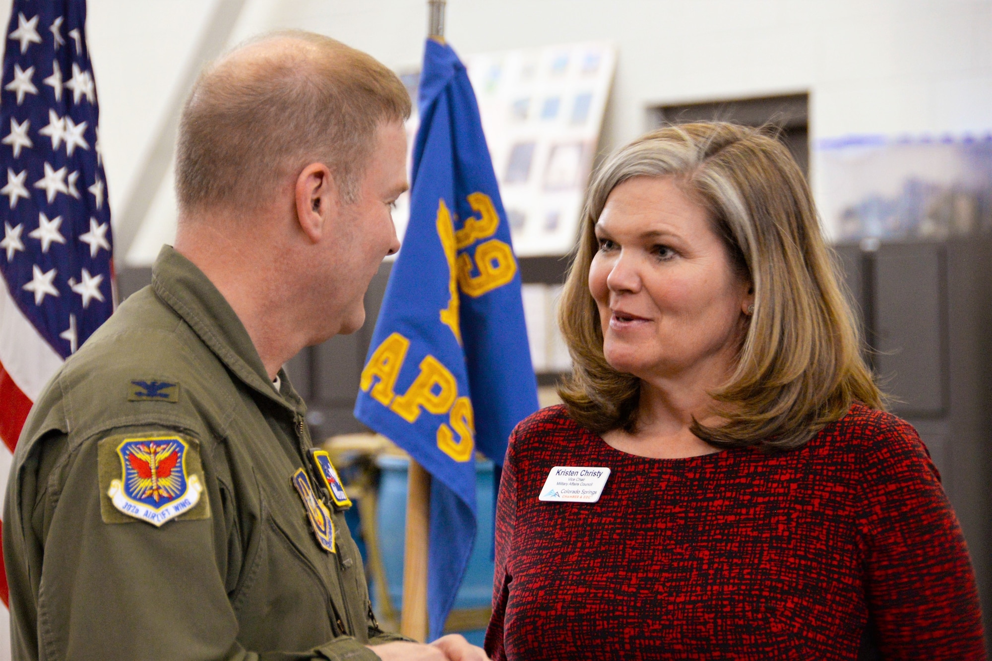 Col. James DeVere, the 302nd Airlift Wing commander, speaks with Kristen Christy, the Colorado Springs Chamber & EDC’s Military Affairs Council vice chair, during the Area Chiefs of Staff luncheon held at Peterson Air Force Base, Colorado March 21, 2018.