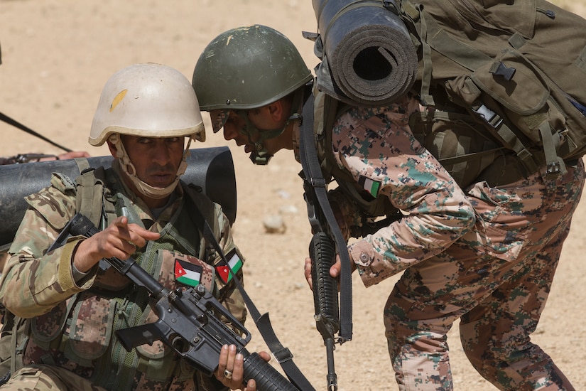 An assistant squad leader reports to his squad leader during a simulated patrol as part of the culminating exercise of the Jordan Armed Forces Noncommissioned Officer Academy Squad Leader Course, March 21, 2018, near Amman, Jordan. U.S. advisors assisted in the development of the Jordanian-led course.