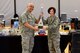 Lt. Col. Jerome Vinluan, Armed Services Blood Program deputy director, presents Col. Patricia Fowler, 436th Medical Group commander, with an award for winning a blood drive challenge March 19, 2018, at Dover Air Force Base, Del. The challenge took place last quarter against Joint Base Andrews, Md. (U.S. Air Force Photo by Airman 1st Class Zoe M. Wockenfuss)