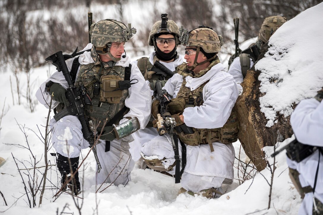 Soldiers discus a route plan to their next objective.