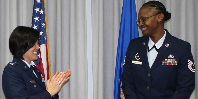 Col. Janette Thode, 340th Flying Training Group commander, congratulates Master Sgt. Faith Wells after promotion ceremonies at Joint Base San Antonio-Randolph, Texas. (Air Force photo by Tech. Sgt. Brianne Blackstock)