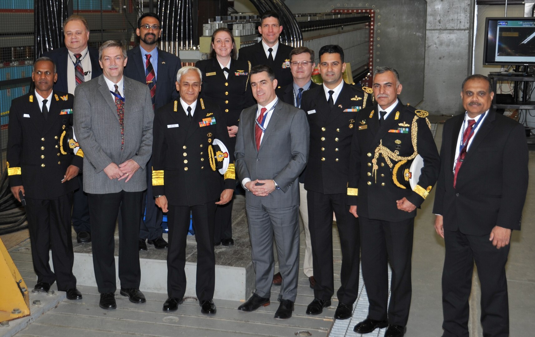 IMAGE: DAHLGREN, Va. (March 22, 2018) - Indian Navy Chief Adm. Sunil Lanba, center, and his delegation are pictured with Naval Surface Warfare Center Dahlgren Division (NSWCDD) leadership in front of the electromagnetic railgun prototype launcher. Lanba led the Indian delegation on an NSWCDD tour that included technical briefings on the U.S. Navy's Aegis Combat System, Directed Energy, and Electromagnetic Railgun Programs. They saw how the command integrates and develops complex warfare systems to incorporate electric weapons technology into existing and future fighting forces and platforms. Navy pilots from Naval Air Warfare Center Aircraft Division also briefed India's top admiral as he flew aboard an MH-60R Seahawk for a demonstration of the helicopter's capabilities. The MH-60R Seahawk missions are anti-submarine warfare, anti-surface warfare, surveillance, communications relay, combat search and rescue, naval gunfire support and logistics support. 

Lanba's NSWCDD visit came on the heels of his meeting with U.S. Chief of Naval Operations Adm. John Richardson at the Pentagon. The two heads of Navy met with U.S. Secretary of the Navy Richard Spencer on March 21 to discuss ways the two nations could improve interoperability that include additional naval exercises and staff talks. "The relationship between the U.S. Navy and the Indian Navy has never been stronger," said Richardson. "There has been meaningful progress made in strengthening the cooperation between our two great democratic and maritime nations. We are exploring every way to expand that partnership even further based on our shared interests."