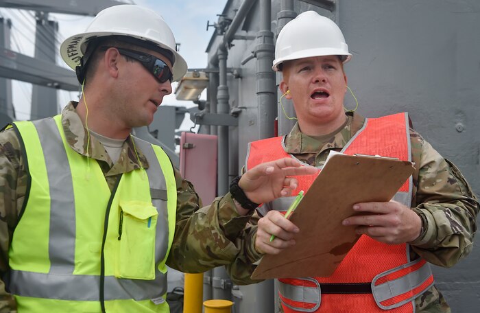 U.S. Army Sgt. David Huffman, left, and Pfc. Michael Weiser, right, both of the 76th Expeditionary Terminal Operations Element, prepare vehicles assigned to the 82nd Airborne Division for transport aboard the USNS Watson (T-AKR-310) at Joint Base Charleston’s - Weapons Station, S.C., March 20. The 841st Transportation Battalion, 597th Transportation Brigade, on-loaded more than 1,500 vehicles and equipment, including combat helicopters. Charleston has the capability to transport cargo by air, land, rail and sea.