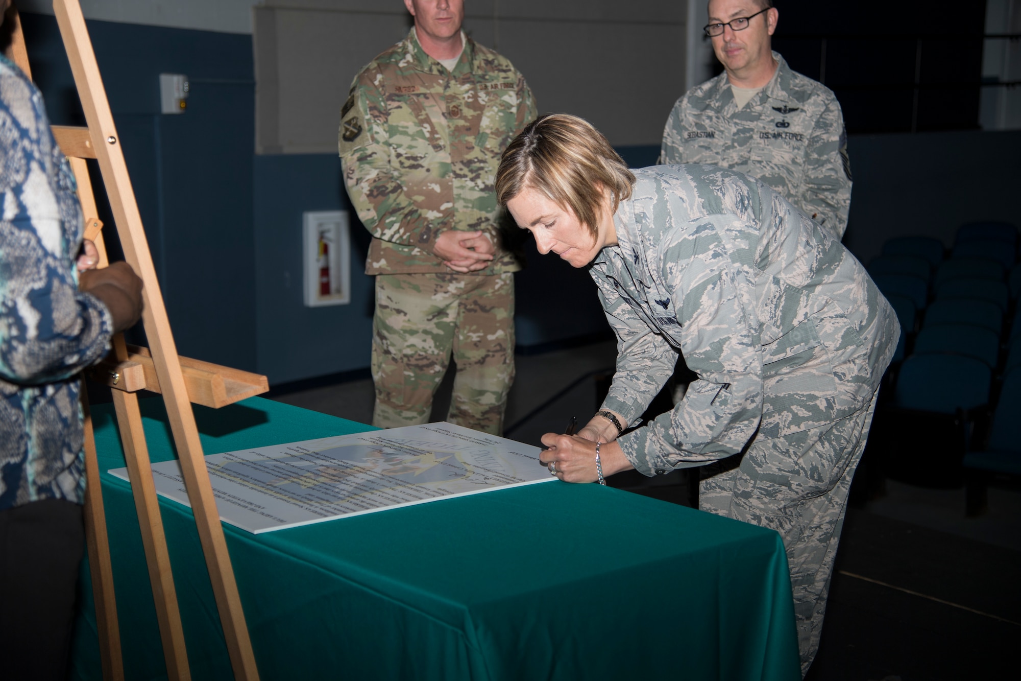Col. Jennifer Short, 23d Wing commander, signs a proclamation, March 26, 2018, at Moody Air Force Base, Ga. The proclamation was signed by base leadership to declare the month of April 2018 as Sexual Assault Awareness and Prevention Month for Team Moody. This year’s theme is “Protecting Our People, Protects Our Mission.” (U.S. Air Force photo by Staff Sgt. Olivia Dominique)