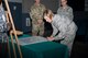 Col. Jennifer Short, 23d Wing commander, signs a proclamation, March 26, 2018, at Moody Air Force Base, Ga. The proclamation was signed by base leadership to declare the month of April 2018 as Sexual Assault Awareness and Prevention Month for Team Moody. This year’s theme is “Protecting Our People, Protects Our Mission.” (U.S. Air Force photo by Staff Sgt. Olivia Dominique)