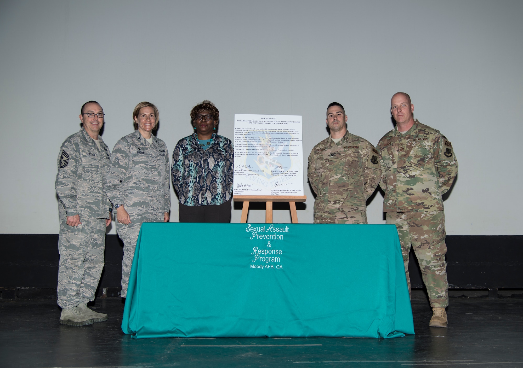 Florine King, 23d Wing Sexual Assault Response Coordinator, center, and base leadership, pose for a photo after a proclamation signing, March 26, 2018, at Moody Air Force Base, Ga. The proclamation was signed by base leadership to declare the month of April 2018 as Sexual Assault Awareness and Prevention Month for Team Moody. This year’s theme is “Protecting Our People, Protects Our Mission.” (U.S. Air Force photo by Staff Sgt. Olivia Dominique)