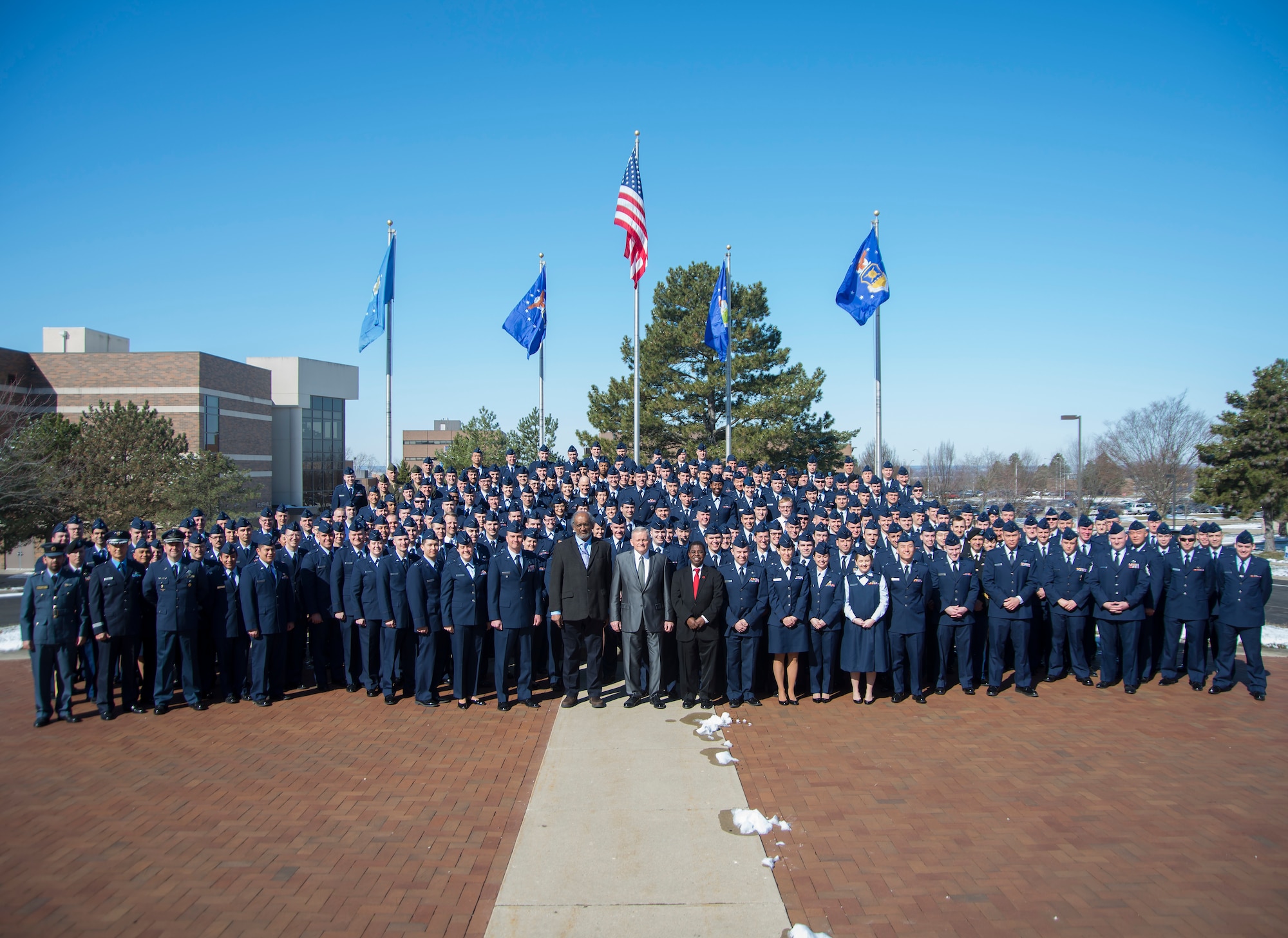 AFIT Senior Leadership including Dr. Todd Stewart, Director and Chancellor, Dr. Sivaguru S. Sritharan, Provost and Academic Dean, and Dr. Adedeji Badiru, Dean, Graduate School of Engineering and Management stand center amongst the AFIT class of 2018. AFIT classes are composed of Air Force, Army, Navy, Marine Corps, international, and civilian students. (U.S. Air Force photo, R.J. Oriez)