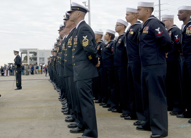 The crew that will man the USS Ralph Johnson (DDG-114) stands in formation during the commissioning ceremony March 24, 2018, in the Port of Charleston, S.C.