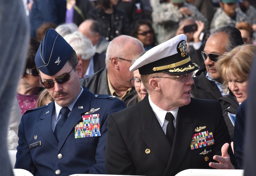 U.S. Air Force Col. Jeffrey Nelson, left, 628th Air Base Wing commander, and U.S. Navy Capt. Robert Hudson, right, Naval Support Activity and Deputy Joint Base Charleston commander attend the commissioning ceremony of the USS Ralph Johnson (DDG-114) March 24, 2018, at the Port of Charleston, S.C.