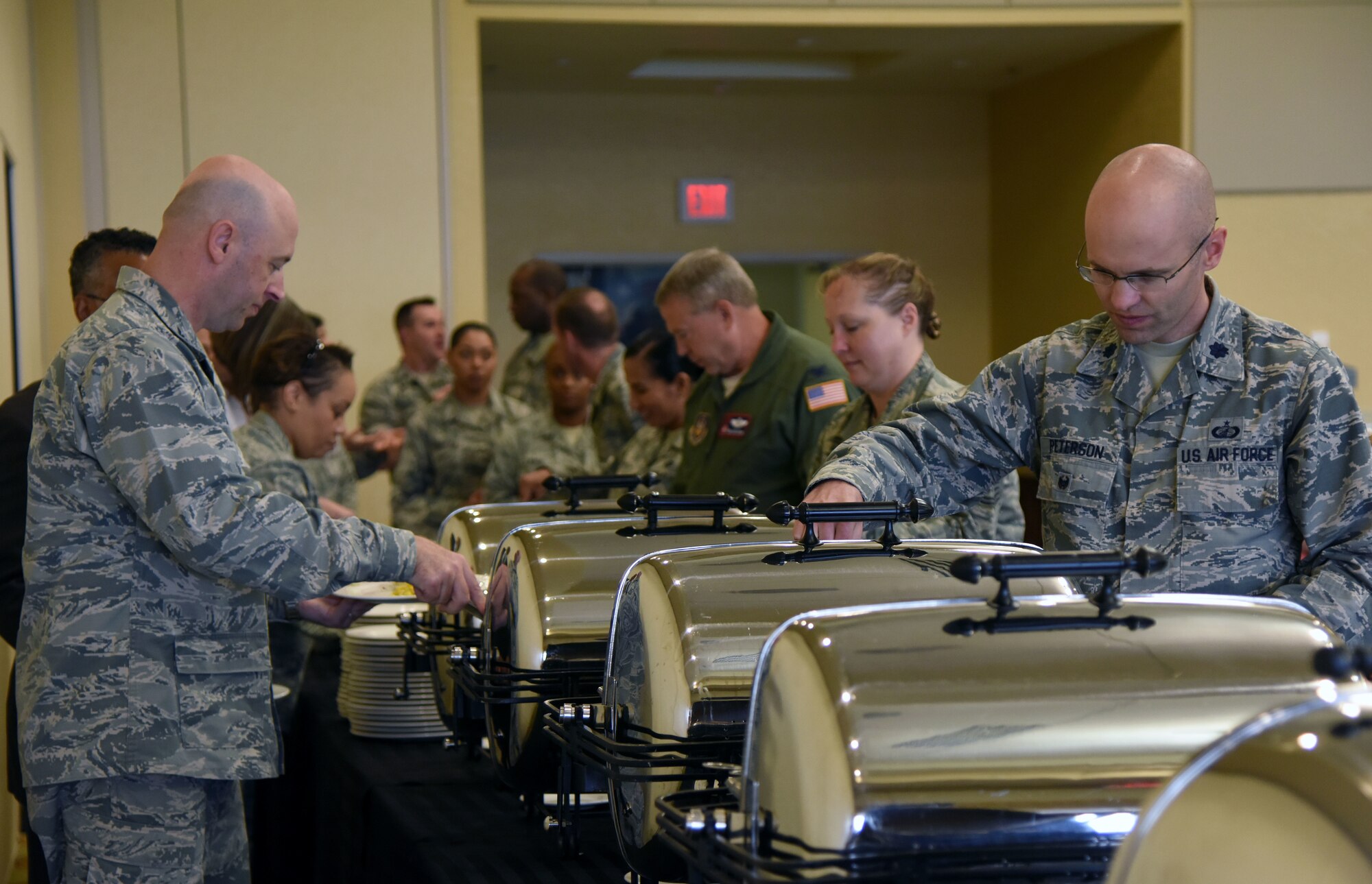 Keesler personnel get food during the Women’s History Month Luncheon at the Bay Breeze Event Center March 27, 2018, on Keesler Air Force Base, Mississippi. The theme for this year’s event is “Nevertheless She Persisted.” (U.S. Air Force photo by Kemberly Groue)