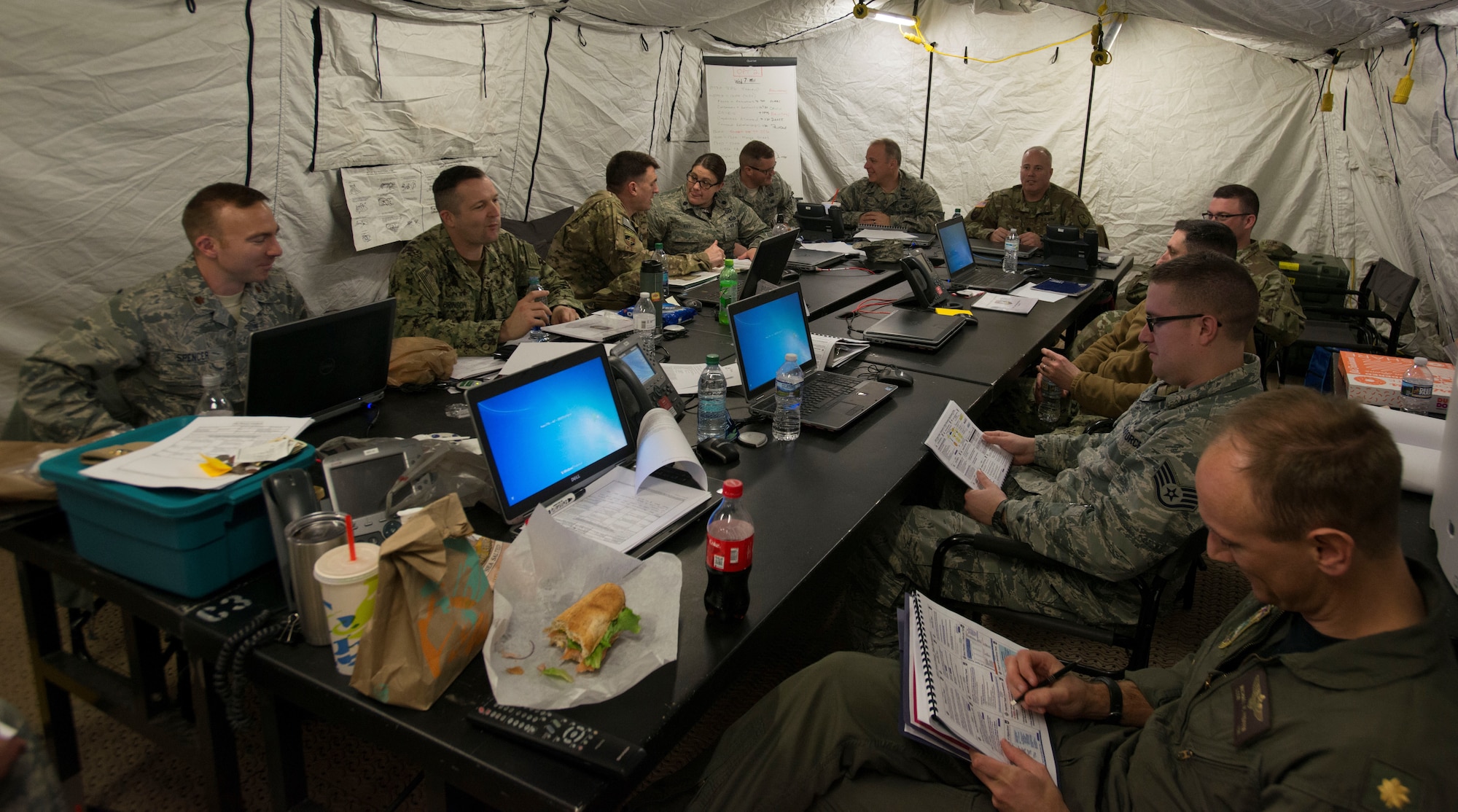 U.S. Airmen from the 9th Air Force, based at Shaw Air Force Base, S.C., and U.S. Soldiers, Sailors, and Airmen from the Joint Enabling Capabilities Command, Naval Station Norfolk, Va., discuss options to present a joint solution during the Joint Task Force-9 Staff Exercise 18-3 at Shaw AFB, March 7, 2018.